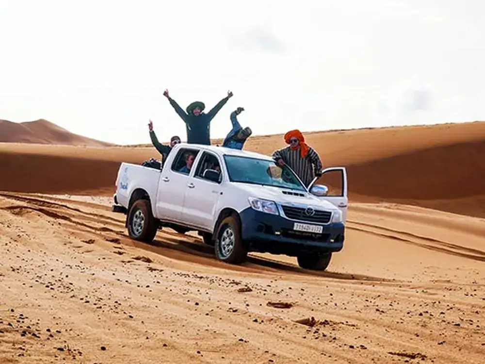 4×4 desert tour with guests at sunset