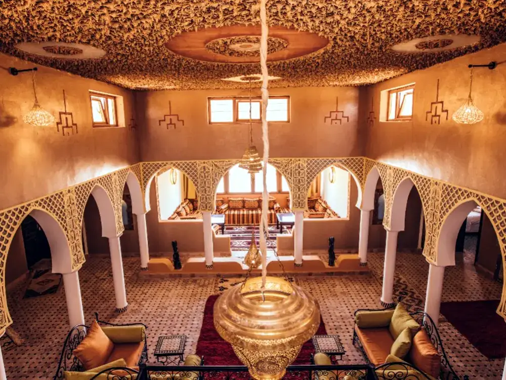 The riad's arched interior courtyard lounge with traditional decor