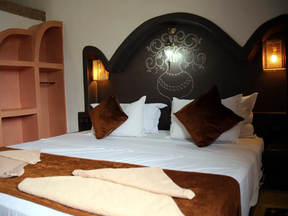 Family room double bed with carved headboard