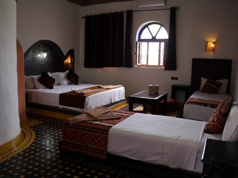 Family room with several beds at Riad Merzouga Dunes