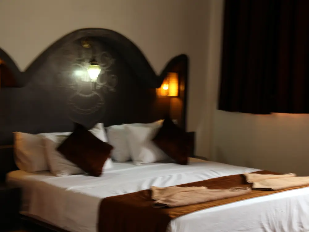 Carved headboard in the triple room
