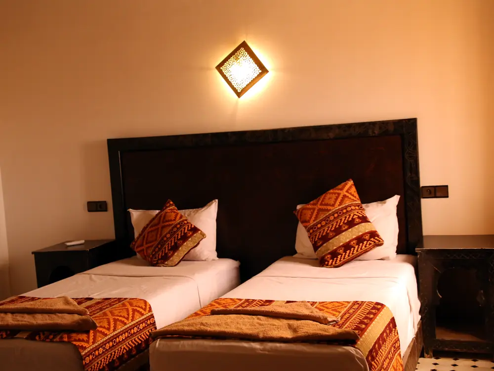 Twin beds with traditional Moroccan cushions