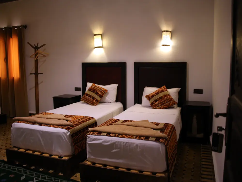 Twin room with two single beds at Riad Merzouga Dunes